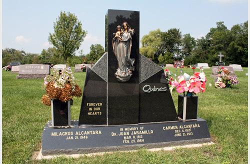 Upright monument with color portrait of religious figures and vases