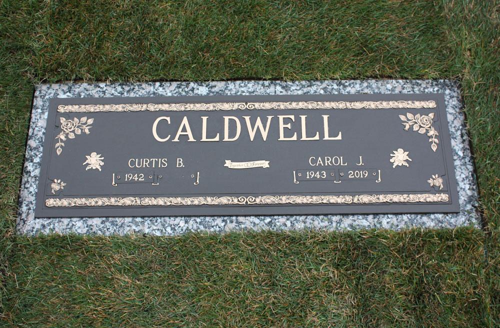 Companion bronze on granite base with roses and angel emblems