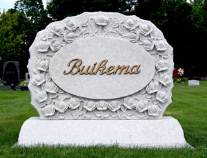 Grey granite family monument with hand-carved roses and bronze letters