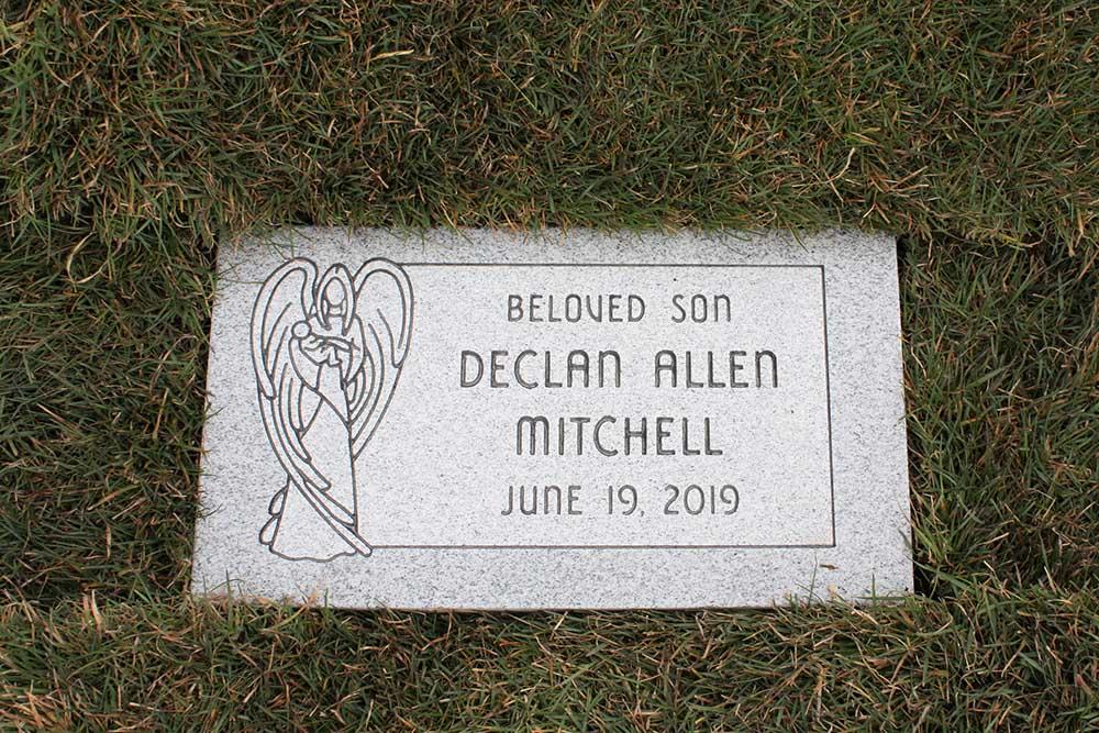 Child's marker with contemporary angel carving