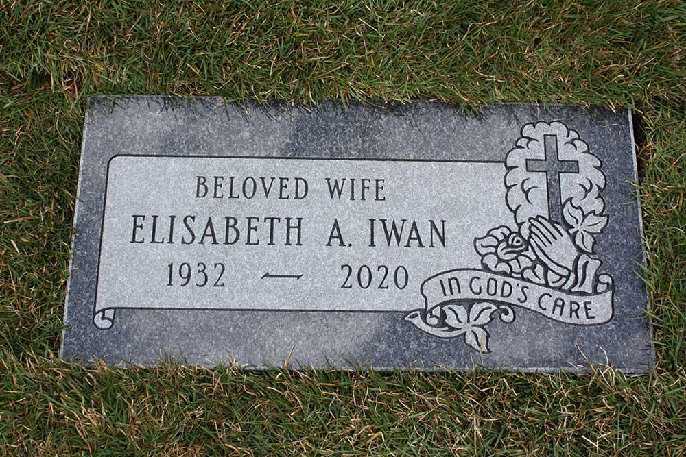 Dark grey marker with cross and praying hands