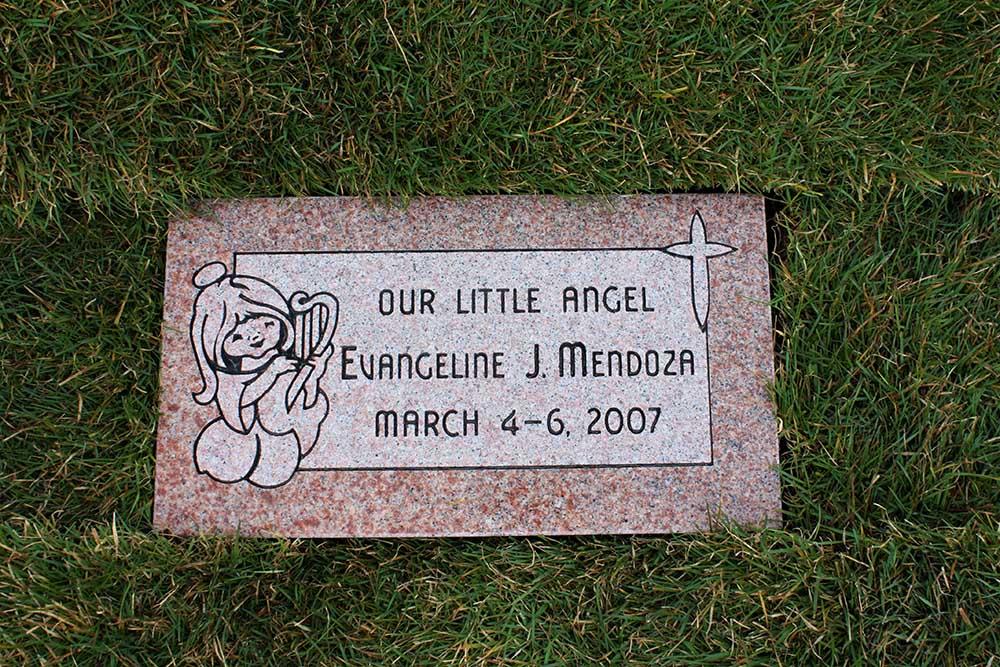 Rose colored child marker with angel and cross