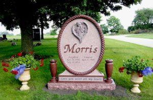 Rose Colored Oval Monument with raised Angel and Verse