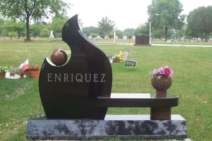 Black and red granite bench monument with flame shape and flower vase