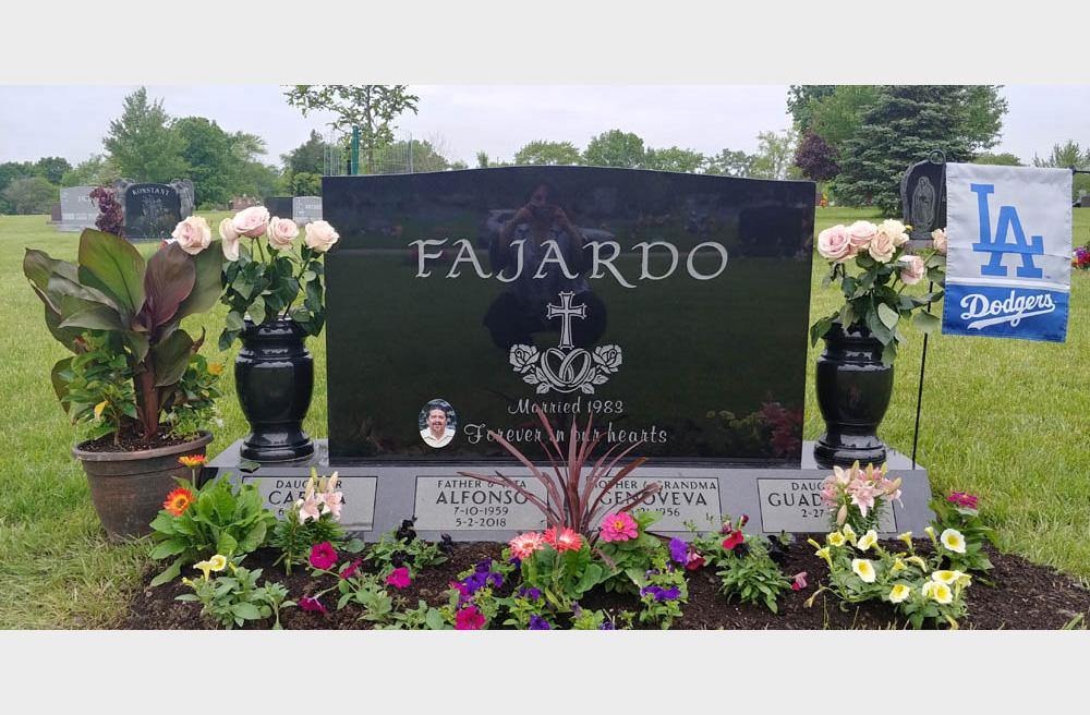 Black granite family monument with ceramic photo and vases
