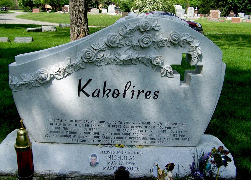 White granite family monument with cross cutout, verse, and ceramic photo